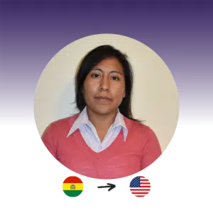 A woman with long black hair and a pink sweater looks at the camera. The Bolivian flag points to the U.S. flag.